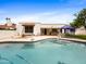 Sparkling swimming pool with patio, seating, and view of the home's exterior at 9637 E Gold Dust Ave, Scottsdale, AZ 85258