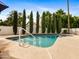 Inviting swimming pool surrounded by lush greenery and a well-maintained patio area for outdoor enjoyment at 9637 E Gold Dust Ave, Scottsdale, AZ 85258