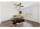 Bright bedroom with wood floors, ceiling fan, and a large window with great natural light at 9801 W Rockwood Dr, Peoria, AZ 85382