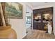 Hallway showcases wood floors and an antique bookcase with a view to the interior at 9801 W Rockwood Dr, Peoria, AZ 85382