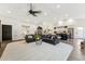 Open concept living area with vaulted ceilings, wood floors, a fireplace and seamless connection to kitchen at 9801 W Rockwood Dr, Peoria, AZ 85382