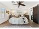 Bright main bedroom boasts wood floors, neutral walls, and a ceiling fan for a cool, calm space at 9801 W Rockwood Dr, Peoria, AZ 85382