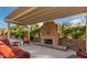 Cozy outdoor fireplace with stylish seating and covered patio at 9801 W Rockwood Dr, Peoria, AZ 85382