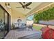 Covered outdoor patio with comfortable seating and a view of the lush backyard at 9801 W Rockwood Dr, Peoria, AZ 85382