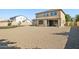 Expansive backyard with desert landscaping and covered patio, ideal for relaxation at 11048 E Quintana Ave, Mesa, AZ 85212