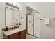 Bathroom featuring granite counters, a walk-in shower, and modern fixtures at 11048 E Quintana Ave, Mesa, AZ 85212