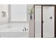 A bathroom featuring a soaking tub, separate shower, and a neutral color palette at 11048 E Quintana Ave, Mesa, AZ 85212