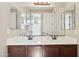 Bathroom featuring dual sink vanity with bronze hardware and a large mirror at 11048 E Quintana Ave, Mesa, AZ 85212