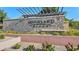 Community sign that reads, 'Highland Ridge', with decorative landscaping and a stone wall at 11048 E Quintana Ave, Mesa, AZ 85212