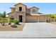 Two-story home with a three-car garage, stone accents, and manicured landscaping at 11048 E Quintana Ave, Mesa, AZ 85212