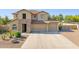 Attractive two-story home featuring a three car garage and well maintained landscaping at 11048 E Quintana Ave, Mesa, AZ 85212