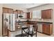 A kitchen featuring stainless steel appliances, a kitchen island with dark wood cabinets at 11048 E Quintana Ave, Mesa, AZ 85212