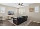 Bright living room featuring ample natural light, a ceiling fan, and stylish decor for a cozy atmosphere at 11048 E Quintana Ave, Mesa, AZ 85212