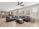 Spacious living room with a large sectional sofa, a ceiling fan, and tile floors at 11048 E Quintana Ave, Mesa, AZ 85212