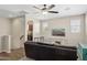 Spacious living room featuring a ceiling fan and a comfortable sofa, perfect for relaxation and entertainment at 11048 E Quintana Ave, Mesa, AZ 85212