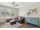 Cozy living room features a comfortable leather sofa, modern decor, and ample natural light at 11048 E Quintana Ave, Mesa, AZ 85212