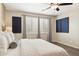 Cozy main bedroom featuring a large window and a comfortable bed, designed for restful nights at 11048 E Quintana Ave, Mesa, AZ 85212