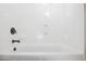 Image shows a full white tub and shower surround with bronze hardware at 11048 E Quintana Ave, Mesa, AZ 85212