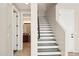 Inviting foyer showcasing a staircase with access to the powder room, blending style with convenience at 11048 E Quintana Ave, Mesa, AZ 85212
