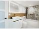 A half wall separates vanity and toilet area from bathtub with shower head at 11601 N 64Th Pl, Scottsdale, AZ 85254