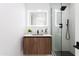 Modern bathroom features a wood vanity, a glass shower enclosure, and neutral walls at 11601 N 64Th Pl, Scottsdale, AZ 85254