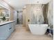 Bright bathroom features a soaking tub, walk-in shower, and stylish vanity with modern finishes at 11601 N 64Th Pl, Scottsdale, AZ 85254