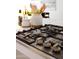Close-up of a sleek gas cooktop with modern knobs and stainless steel accents at 11601 N 64Th Pl, Scottsdale, AZ 85254