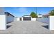 Long, spacious driveway with a white fence and a black garage door providing ample parking space at 11601 N 64Th Pl, Scottsdale, AZ 85254