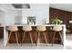 Sleek kitchen island with counter seating, modern appliances, and attractive wood paneling at 11601 N 64Th Pl, Scottsdale, AZ 85254
