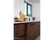 Modern kitchen features beautiful marble backsplash, elegant countertops, and sleek wood cabinets at 11601 N 64Th Pl, Scottsdale, AZ 85254