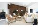 Inviting living room featuring sleek wood paneling, stylish seating, and plenty of natural light at 11601 N 64Th Pl, Scottsdale, AZ 85254
