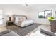 Spacious main bedroom with plush bedding, stylish decor, and ample natural light from a large window at 11601 N 64Th Pl, Scottsdale, AZ 85254