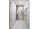 A frameless glass shower has marble walls, mosaic tile floor, and gold fixtures at 11601 N 64Th Pl, Scottsdale, AZ 85254