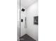 Shower with glass surround, black rain shower head, and mosaic floor and niche at 11601 N 64Th Pl, Scottsdale, AZ 85254