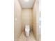 A small toilet room features horizontal textured tile and modern toilet at 11601 N 64Th Pl, Scottsdale, AZ 85254