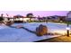 Beautifully lit Zen garden with a wooden bridge and carefully placed rocks, offering a peaceful outdoor space at 11601 N 64Th Pl, Scottsdale, AZ 85254