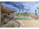 Expansive backyard featuring a pool, covered patio, and desert landscaping for outdoor living at 1217 S Longmore Ct, Chandler, AZ 85286