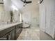 A bright bathroom with double sinks, tiled floor, and a bathtub and shower at 1217 S Longmore Ct, Chandler, AZ 85286