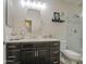 Well-lit bathroom with a single vanity, framed mirror, and a walk-in glass shower provides a modern aesthetic at 1217 S Longmore Ct, Chandler, AZ 85286