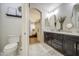 Modern bathroom featuring a double vanity, neutral color palette and an open doorway to the main bedroom at 1217 S Longmore Ct, Chandler, AZ 85286
