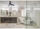 Bright bathroom with a double vanity, free-standing tub, and glass-enclosed shower provides a modern, spa-like feel at 1217 S Longmore Ct, Chandler, AZ 85286