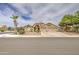Spacious beige home with a manicured lawn and a three-car garage at 1217 S Longmore Ct, Chandler, AZ 85286