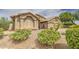 Close up of a beige home with desert landscaping and a three-car garage at 1217 S Longmore Ct, Chandler, AZ 85286