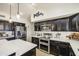Modern kitchen showcasing stainless steel appliances, white countertops, and dark wood cabinets at 1217 S Longmore Ct, Chandler, AZ 85286