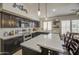 This kitchen features a large quartz countertop, dark cabinets, and stainless steel appliances at 1217 S Longmore Ct, Chandler, AZ 85286