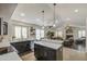 Open-concept kitchen with dark cabinets, a bright living space, and stainless steel appliances at 1217 S Longmore Ct, Chandler, AZ 85286