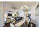 Open-concept living room with a dark wood dining table and chandelier at 1217 S Longmore Ct, Chandler, AZ 85286