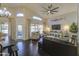 Bright living room featuring high ceilings, hardwood floors, and a comfortable leather sofa at 1217 S Longmore Ct, Chandler, AZ 85286