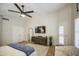 Bright main bedroom featuring a large closet, ceiling fan, and light-colored walls at 1217 S Longmore Ct, Chandler, AZ 85286