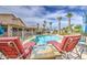 Resort-style backyard with a pool, lounge chairs, and lush landscaping, perfect for entertaining at 1217 S Longmore Ct, Chandler, AZ 85286